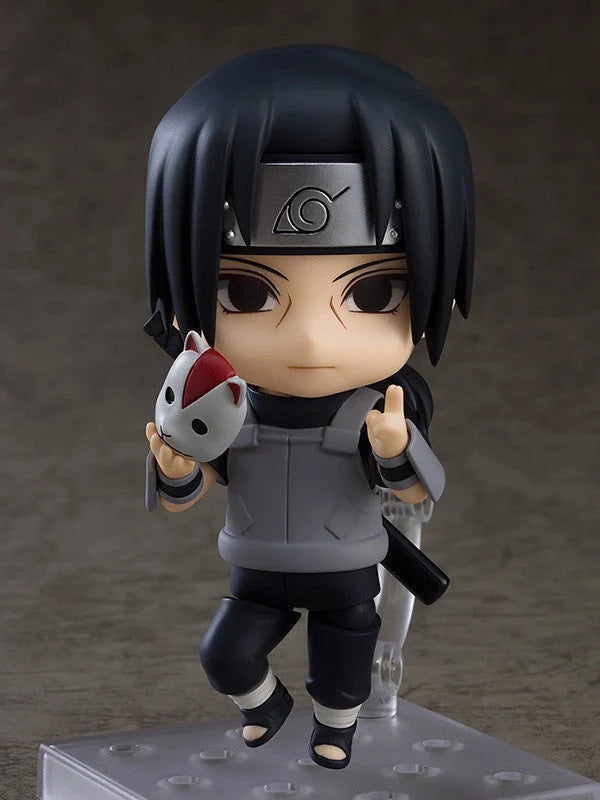 Ninja chibi action figure with black hair, holding white-and-red fox-like mascot, gray outfit