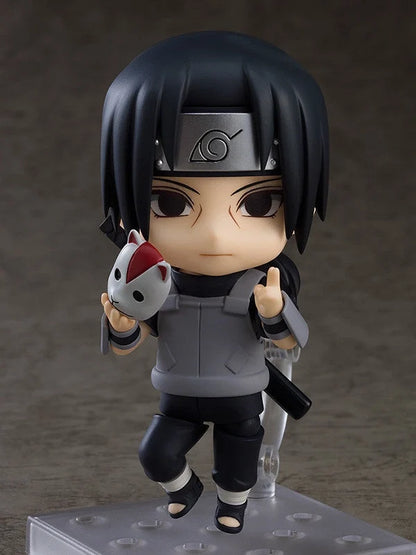 Ninja chibi action figure with black hair, holding white-and-red fox-like mascot, gray outfit