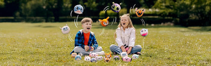 Plush animal toy set outdoors; brown dog plush with wide embroidered eyes.