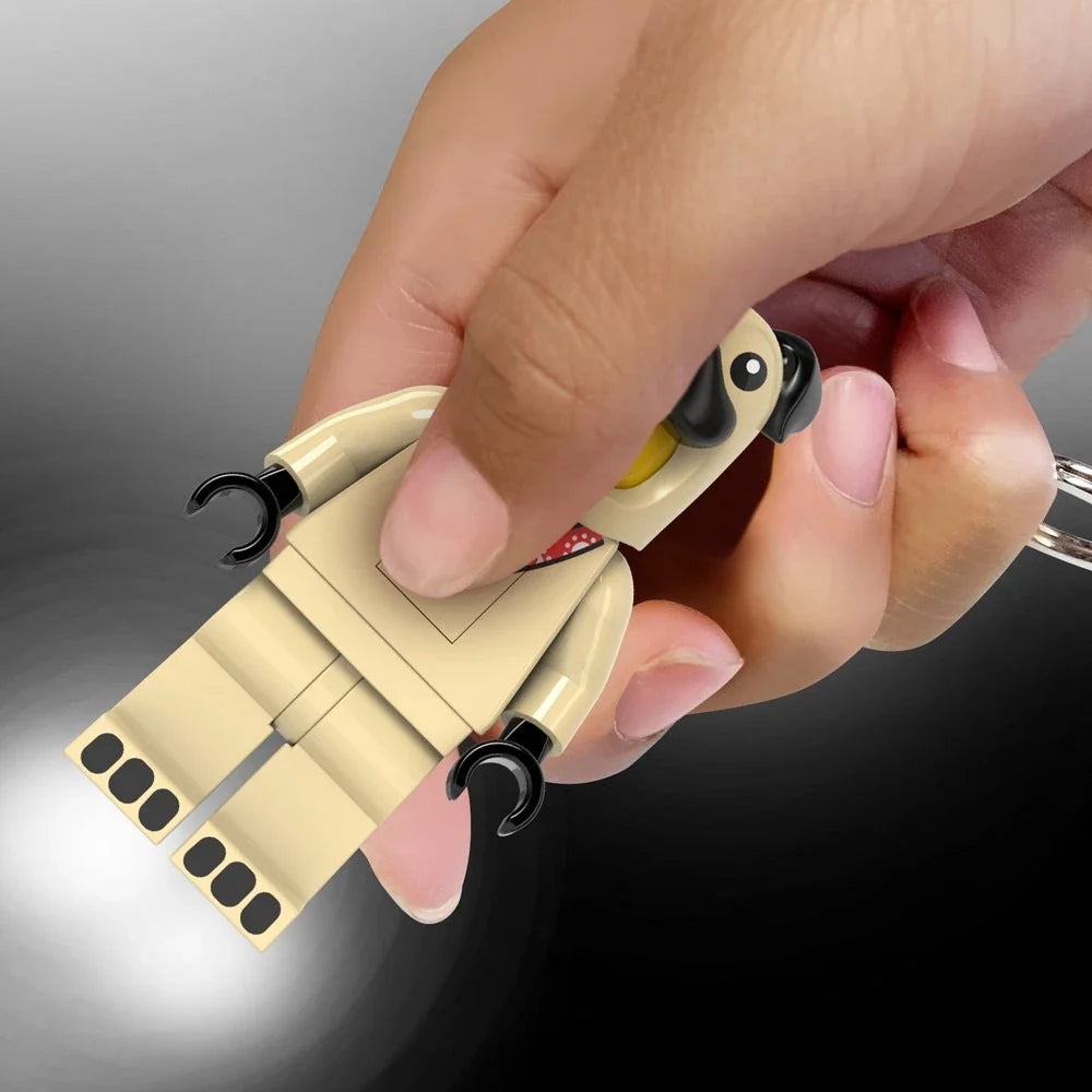 Pug design keychain light with beige figure, black ears, and lit LED front