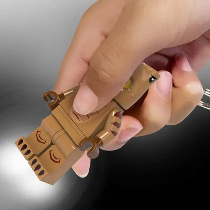 T-Rex costume LED key chain in tan with molded dinosaur face and eye detail