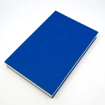 Blue notebook with white page edges, closed cover with small clip