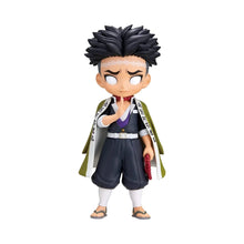 Chibi anime figure with spiky black hair, purple top, dark pants, and white-green haori