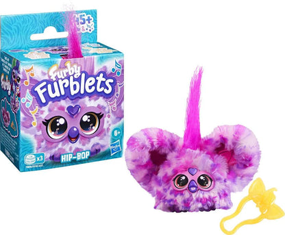 Purple and pink plush toy cat with oversized glasses-like eyes and yellow tail accessory
