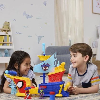 Toy pirate ship with face sail and character figures on tabletop.
