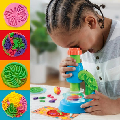 Child using blue light scope toy, pressing dough with orange top