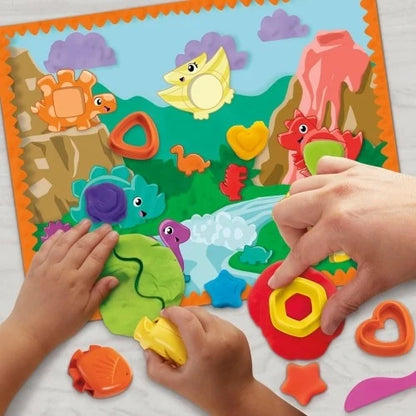 Play-Doh dinosaur scene mat with animal shapes and hands molding colorful dough