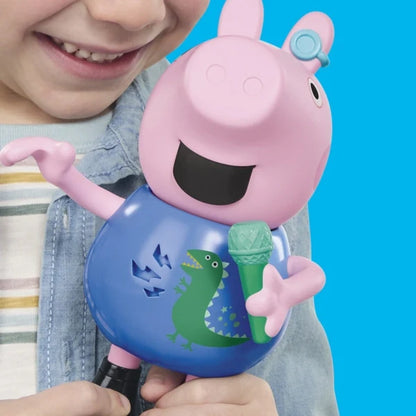 George Pig character figure held by child, smiling, blue dinosaur shirt, black boots