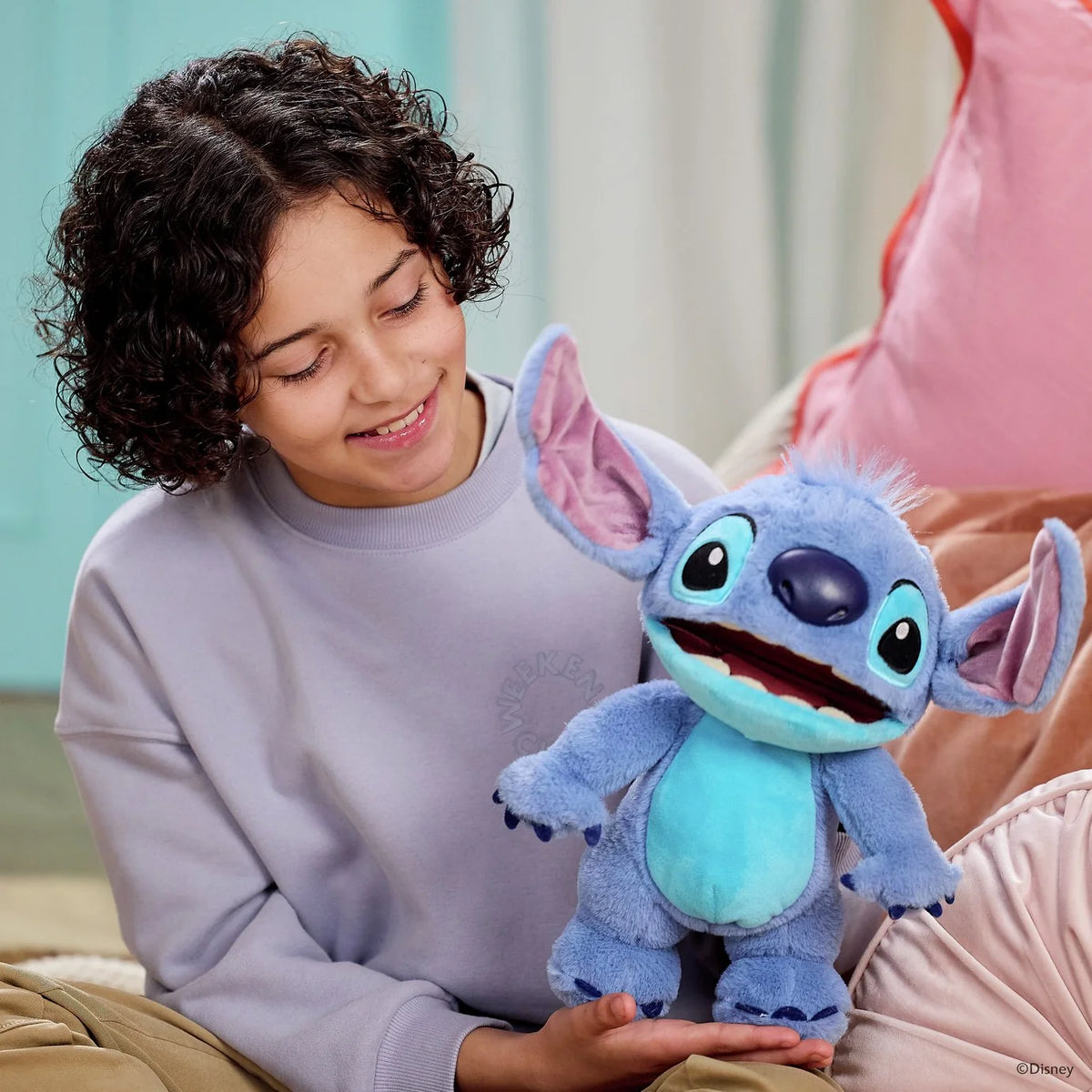 Blue Stitch plush chat puppet held by a child, purple ears and big eyes