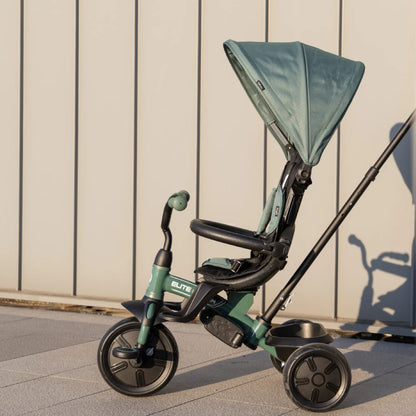 Green tricycle stroller with canopy, reclining seat and three large wheels