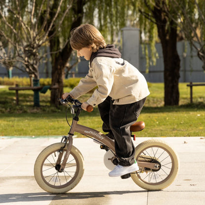Kids balance bike with tan frame, white fork, and orange handlebar grips