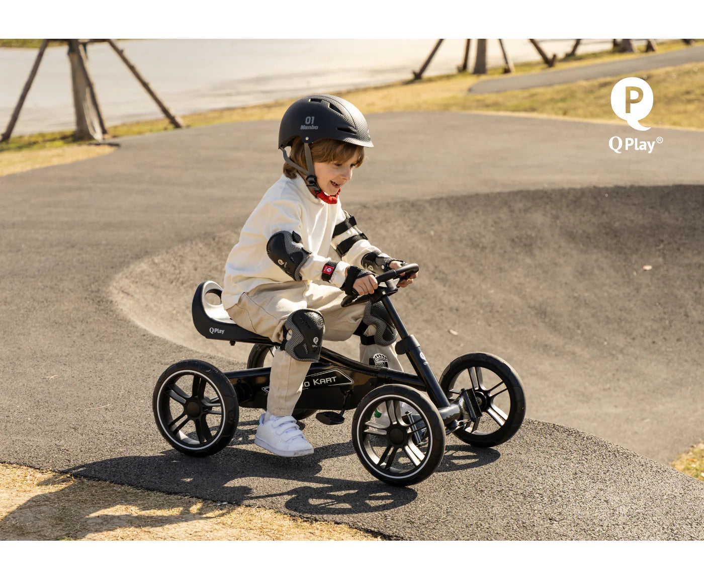 Black QPlay pedal go-kart with a child seated on the seat