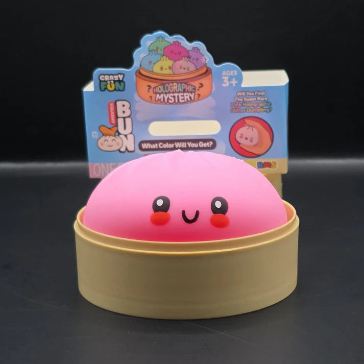 Pink dome-shaped holographic dumpling squishy fidget toy with face