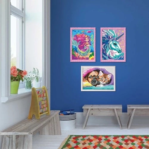 Three framed unicorn paint-by-numbers artworks on wall, with blue-and-pink accents