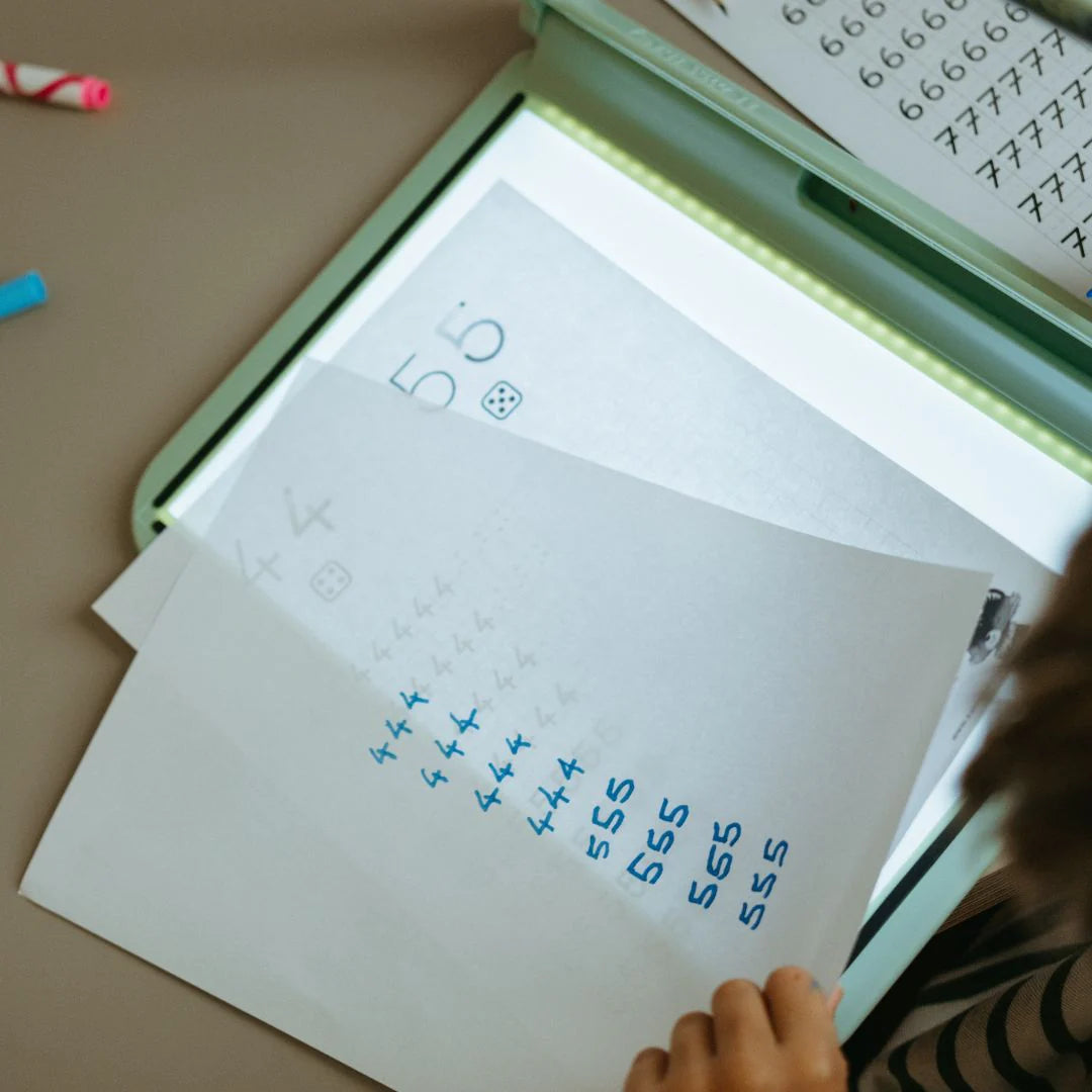 Close-up of A4 light drawing tablet with illuminated screen and scribbled letters