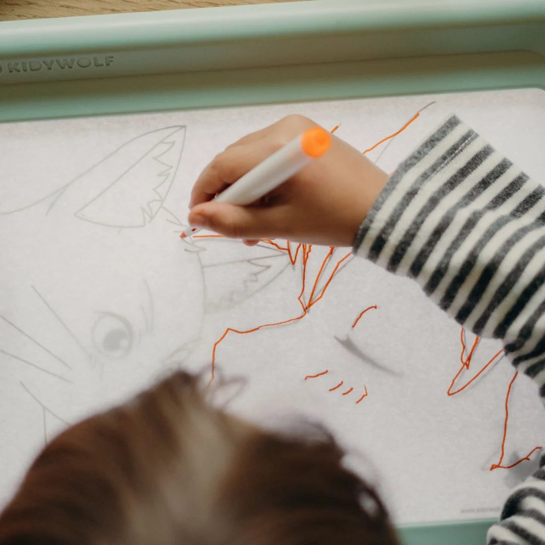 Kids marker set: close-up of an orange-tip marker on a drawing tablet