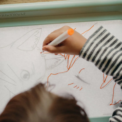 Kids marker set: close-up of an orange-tip marker on a drawing tablet