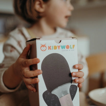 Karaoke microphone box held by a child hand, showing pink microphone image