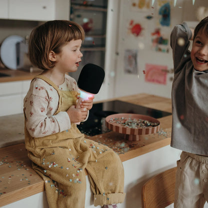 Kids karaoke microphone with pink handle and black foam windscreen
