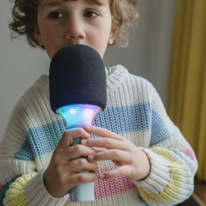 Kidymic karaoke microphone close-up: dark foam head, mint handle, glowing LED ring