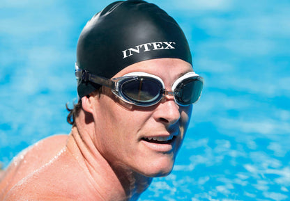 Swimming goggles with tinted lenses on a swimmer wearing an adjustable strap