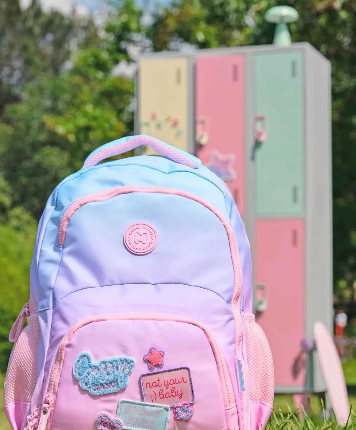 Pastel lavender backpack front with embroidered patches and front zip pocket