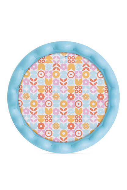 Wavy edge inflatable pool with light blue rim and floral patterned base, top view