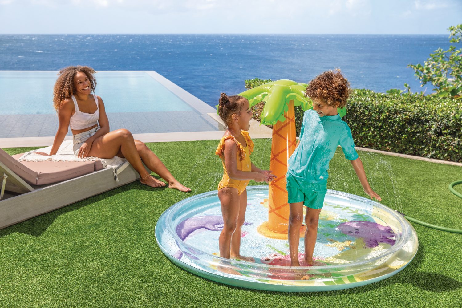 Inflatable palm-spray pool with green canopy and orange trunk, sea-animal design