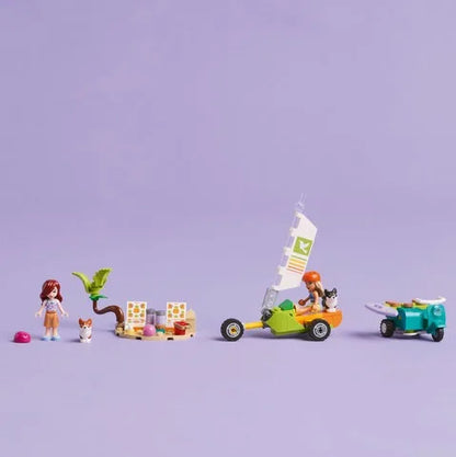 Toy building set scene with minifigures, two toy dogs, scooter, and stacked boxes