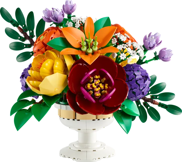 Flower arrangement centerpiece with large maroon bloom, orange and purple petals, green leaves