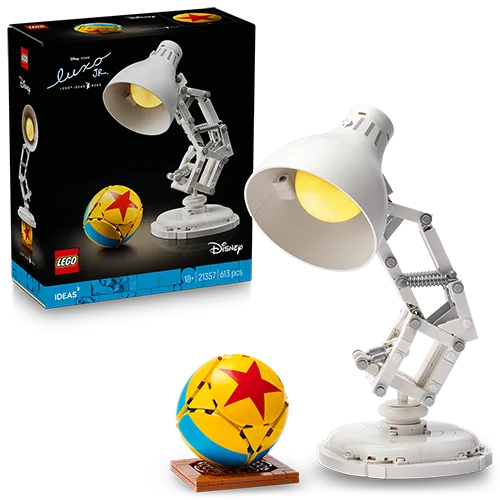 White adjustable desk lamp with wide shade and yellow light on a build stand