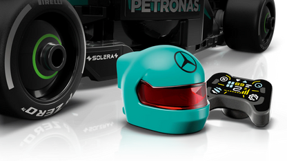Teal driver helmet and steering controls on Mercedes-AMG F1 W15 race car model.