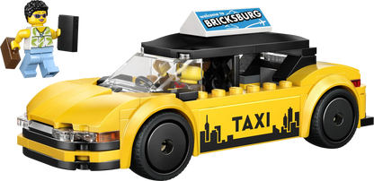 Yellow taxi toy car with roof sign and TAXI lettering, front 3/4 view