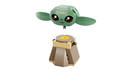 Grogu figure on a rotating base stand with a yellow circular top plate
