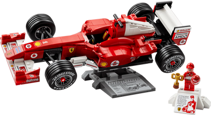 Ferrari F2004 red race car model with front and rear wheels, sponsor panels and stand