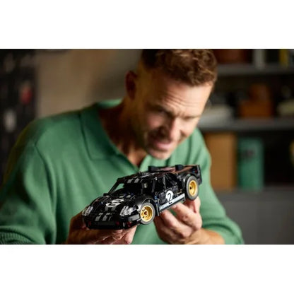 Race car model with black body, silver panels, gold wheels, number 2 detail