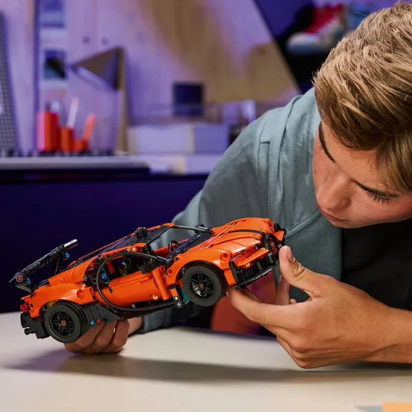Orange sports hypercar model with black wheels and rear aero details.