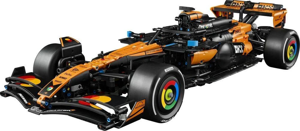 LEGO Technic race car model in orange and black, low angle view with large front tires