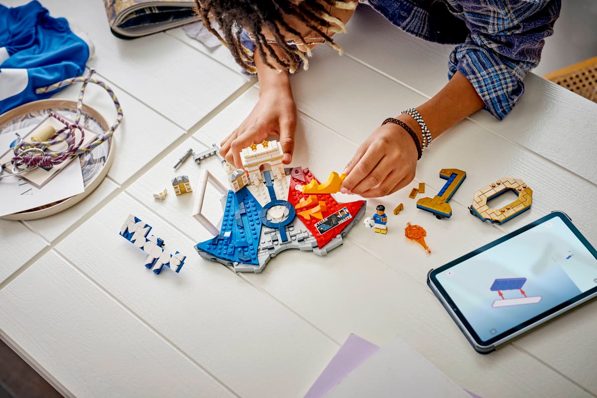 Soccer-themed building set being assembled by hands