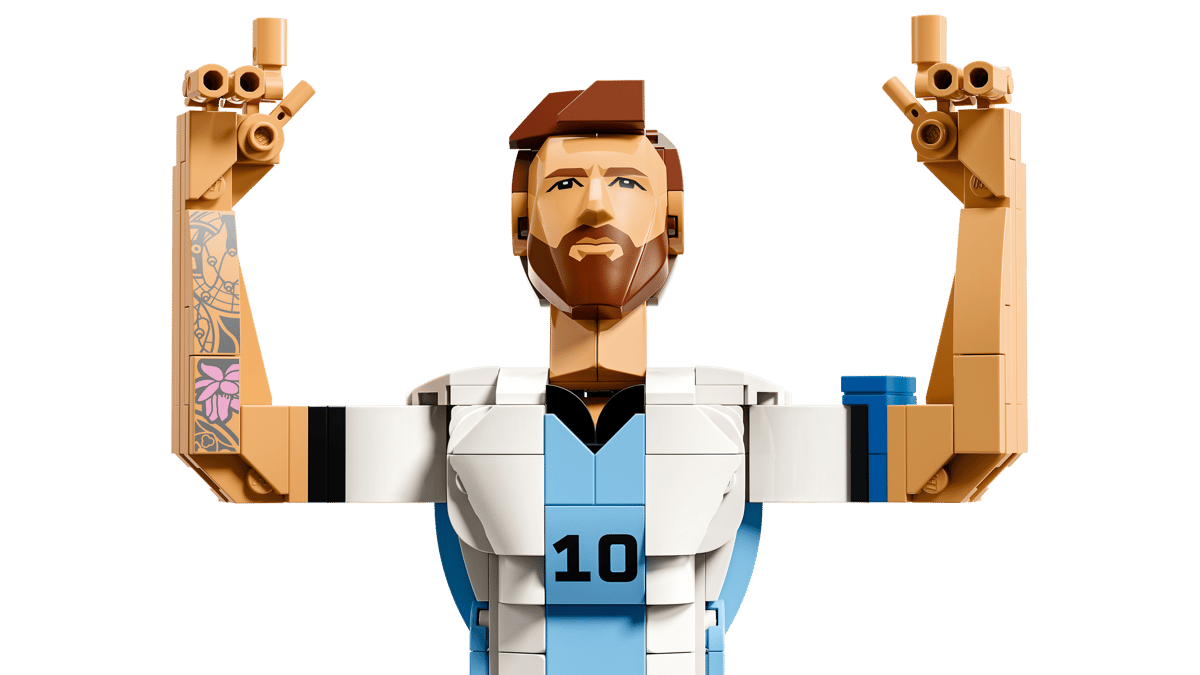 Close-up of Messi minifigure head and raised arms in white-and-blue outfit