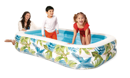 Inflatable family pool with tropical leaf fabric, white edges and blue inner floor