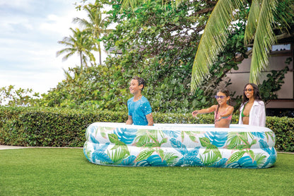 Inflatable family pool with wide tropical leaf pattern and blue interior basin