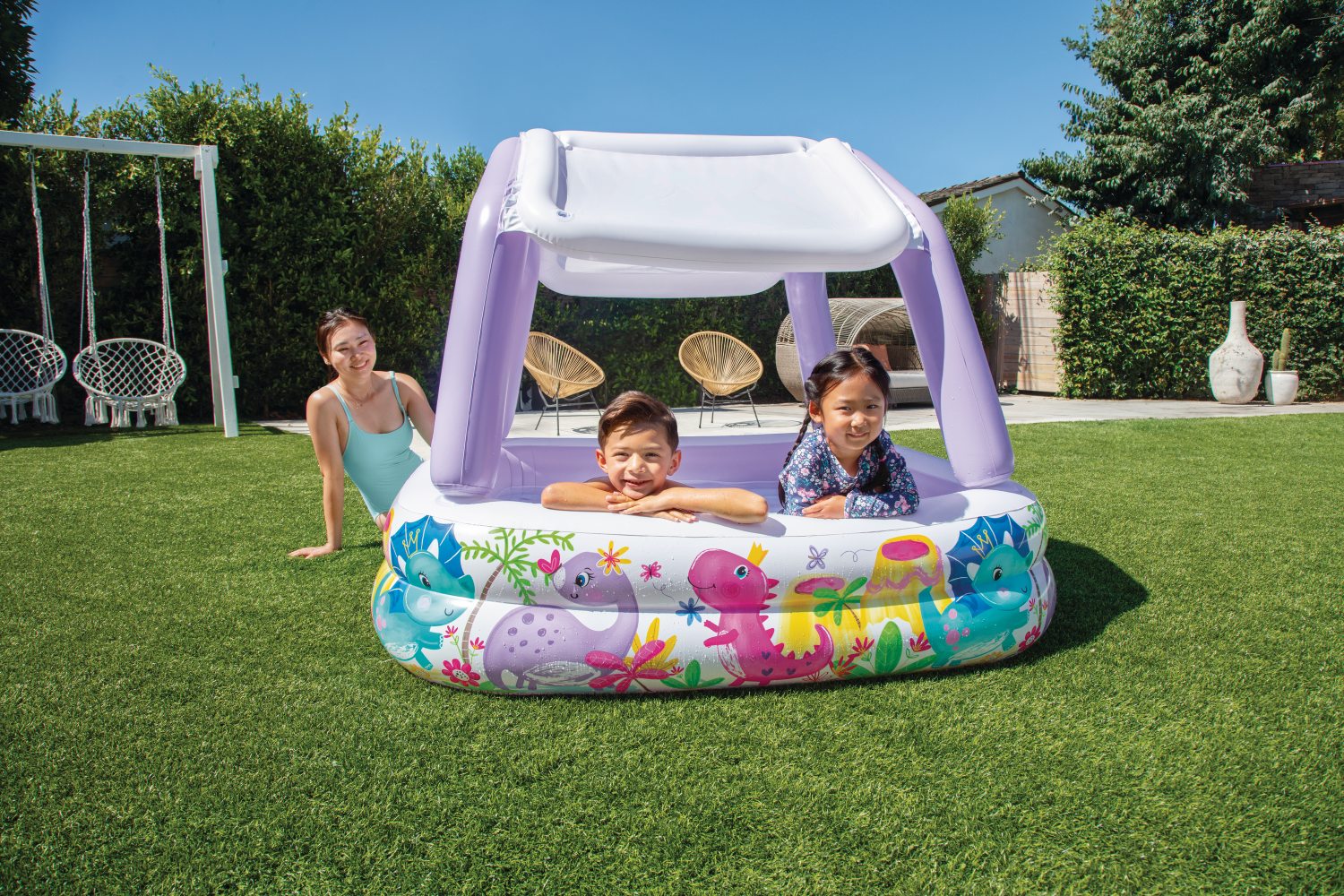 Inflatable kids pool with white canopy and lavender support poles, sea-animal graphic