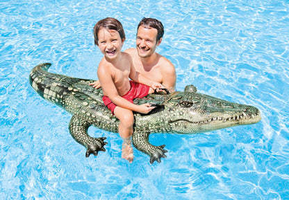 Green gator ride-on toy with textured scales, carrying a child and adult