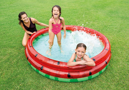 Inflatable watermelon pool with red rim and green floor, black seed graphic