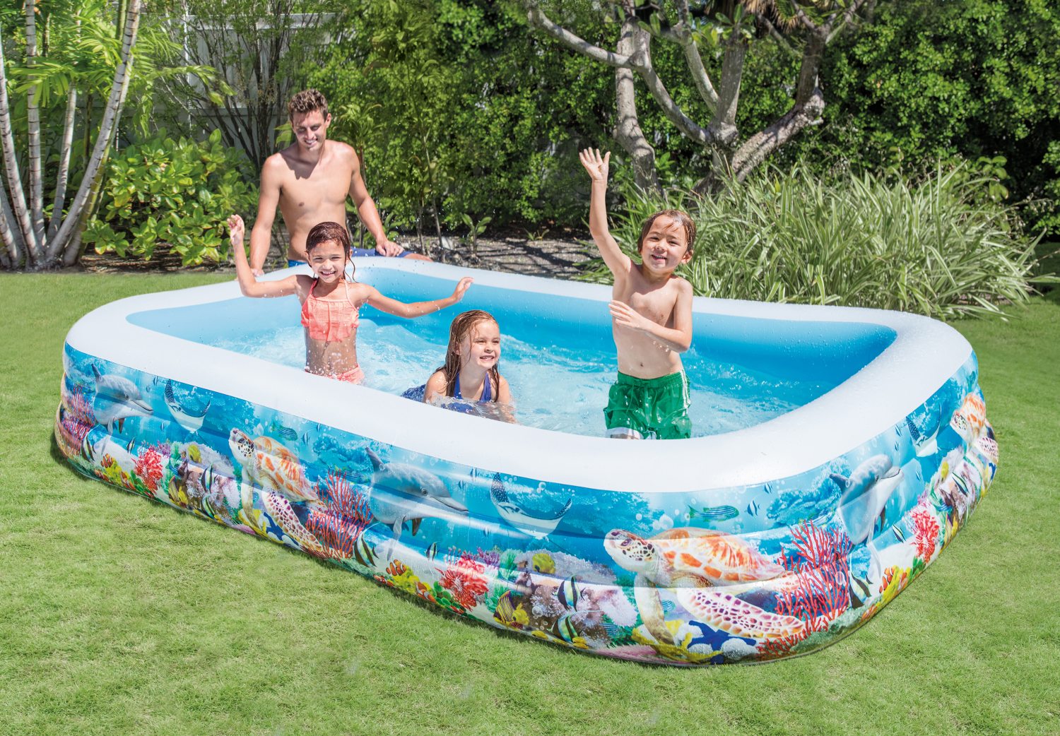 Inflatable rectangular pool with sea-life print sides and white rim, family splashing in water