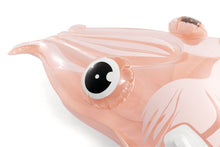 Cuttlefish float pool toy in light pink with large black-and-white eye close-up