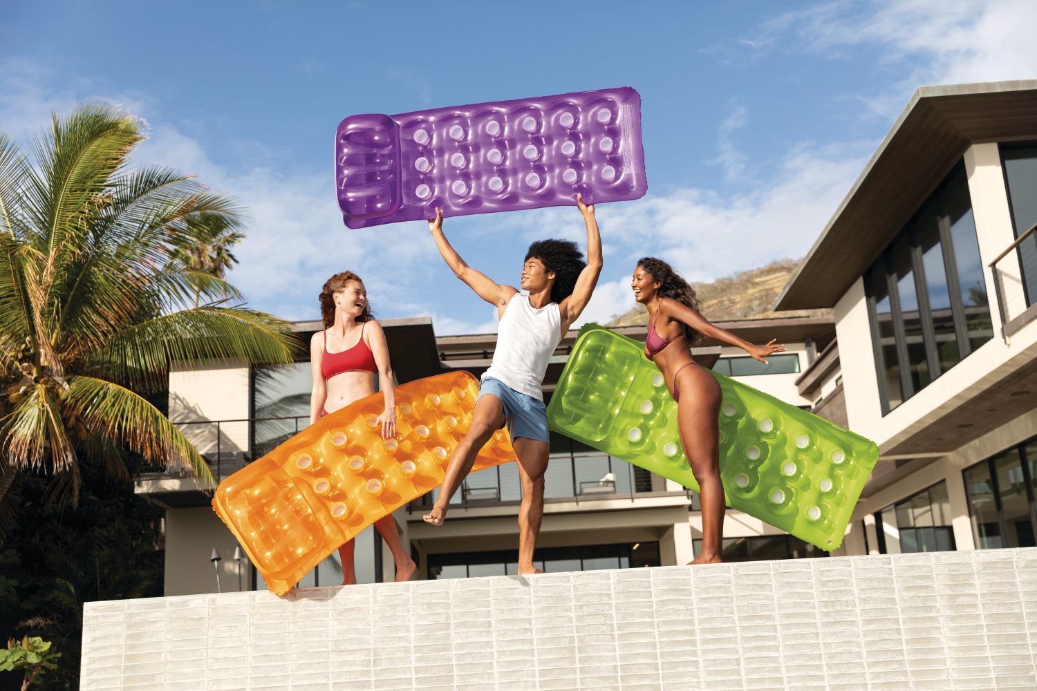 Inflatable 18-pocket fashion mats in purple, orange, and green held during play