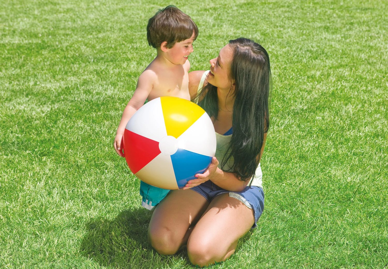 Glossy panel ball held by two children; white, yellow, red, and blue panels