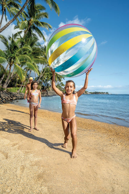 Jumbo beach ball with rainbow stripes, held overhead